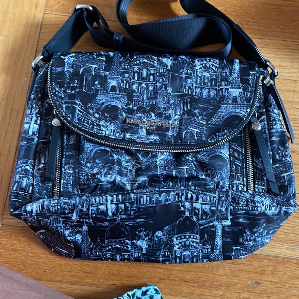 Nylon black with Paris scenery. Lots of pockets. Great for travel